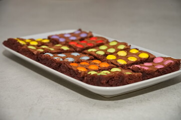 Closeup of plate with chocolate cookies on white table