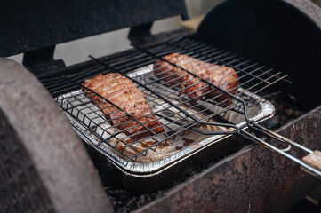 Smoked grilled meat. Cut off a large piece of smoked pork belly.