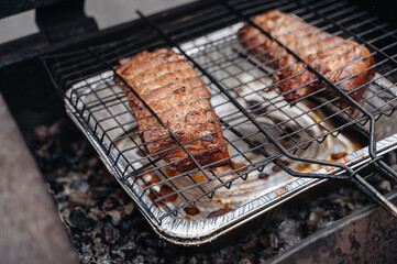 Smoked grilled meat. Cut off a large piece of smoked pork belly.