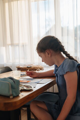 Cute little girl paints with paints
