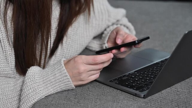 Beautiful young woman using laptop, shopping online at home