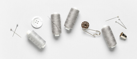 Fototapeta premium Sewing supplies on light background, top view