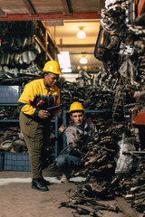 African women with engineer man staff worker working heavy industry old part warehouse