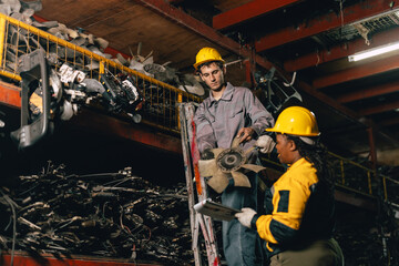 African women with engineer man staff worker working heavy industry old part warehouse