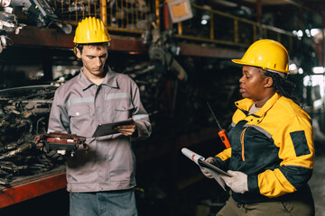 African women with engineer man staff worker working heavy industry old part warehouse