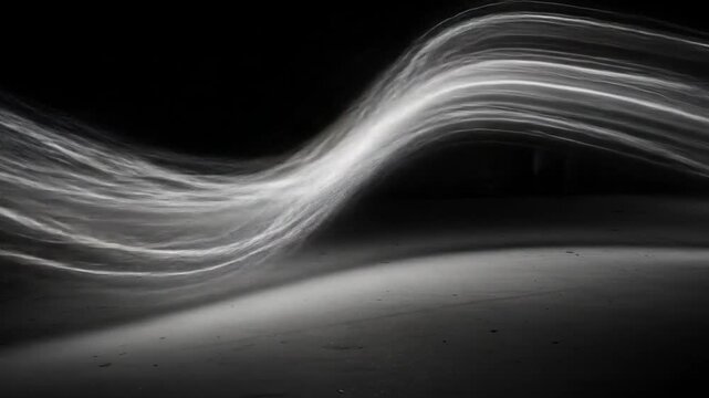 Abstract light trail forms against black background