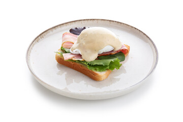 Plate with tasty egg Benedict on white background