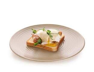 Plate of delicious egg Benedict with bacon and micro green on white background