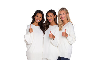 Three diverse, smiling young women in white sweaters giving thumbs up, representing unity and happiness