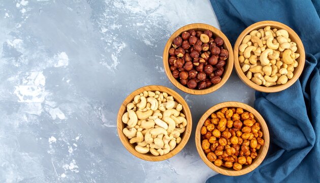 Overhead Shot of Assorted Nuts in Wooden Bowls on Surface