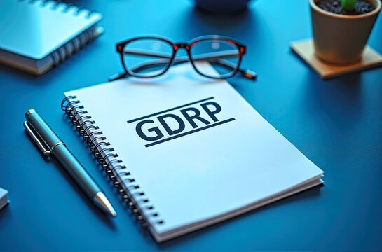 Notebook with GDRR Text, Pen, Glasses and Coffee on Desk