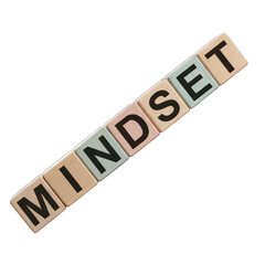 Wooden letter blocks spell "MINDSET" on a black background, angled for impact