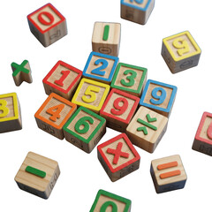 Wooden blocks with bright numbers and math symbols, scattered on a dark background