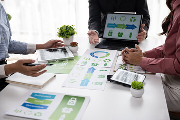 Collaborative sustainability strategy meeting office business presentation indoor teamwork environmental awareness