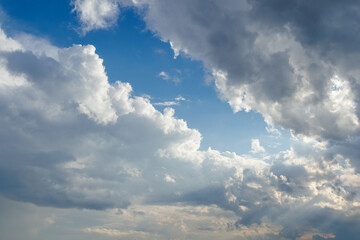 Dramatic sky with sunlight and cumulus clouds