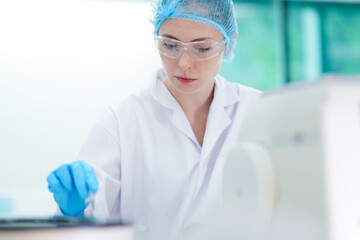 A geneticist prepares a crucial DNA sample for genomic sequencing, using sterile tweezers to prevent cross contamination while adhering to strict laboratory protocols for accuracy. © ultramansk