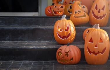 Jack-o-lantern pumpkins on the back porch. Halloween decorations