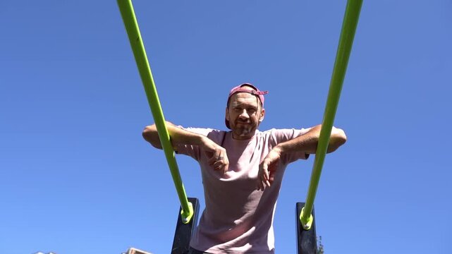 Man Training on Outdoor Bars. Urban Fitness and Street Workout