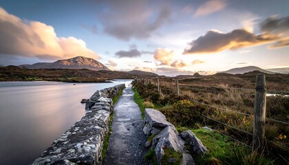 Stone path leads to mountain at tranquil sunset
