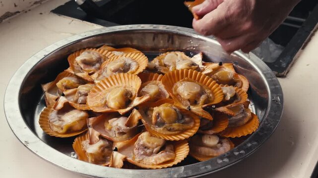 A Cantonese chef prepares steamed scallops with garlic sauce