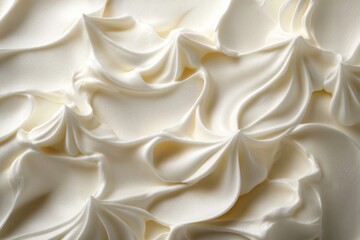 Close-up of smooth creamy white swirls, perfect for dairy, dessert or beauty product backgrounds