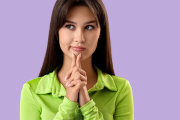 Fototapeta premium Thoughtful young woman on lilac background, closeup