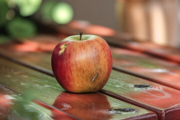 Vibrant Red and Golden Apple Resting on Rustic Wooden Surface. Capturing Freshness and Wholesome...
