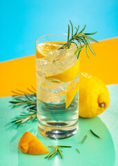 Refreshing cocktail with gin, tonic, lemon, and rosemary.