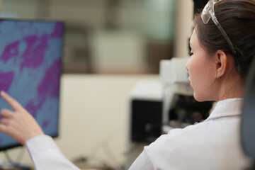 A biomedical researcher uses an AI-powered platform to analyze complex genomic data, identifying a novel biomarker for personalized medicine and accelerating future drug discovery.