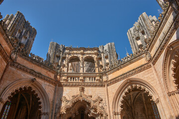 Architectural detail of the unfinished chapel in Batalha with Gothic tracery and pinnacles on a...