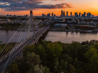 Warsaw city center and skyscrapers in the background Vistula river and Swietokrzyski bridge. Sunset  Warsaw aerial view.