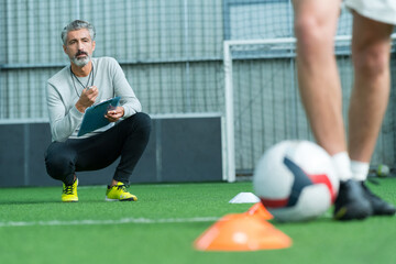 football coach watching young man training
