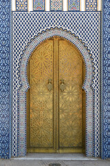 Brass door with Arabic calligraphy and Moroccan zellij mosaic tilework. Royal Palace, Fez, Morocco