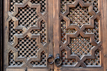 Carved wooden door details with geometric patterns, Bou Inania Madrasa. Fez, Morocco