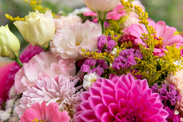 Summer bouquet. Beautiful pink dahlias, lisianthus and zinnias arrangement. Birthday or wedding bouquet made of summer flowers close up.
