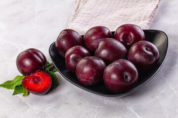 Raw ripe purple plum heap