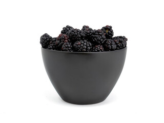 Fresh raw blackberries isolated in dark pot on white background