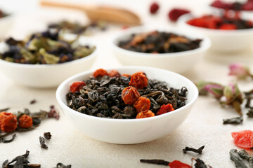 Bowl with healthy berry tea on light grunge background