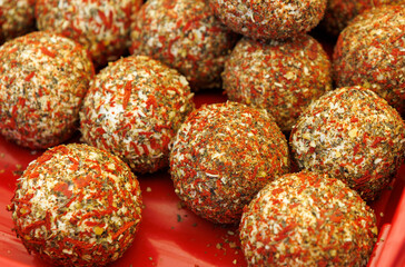 A red tray with many small balls of food on it