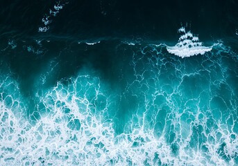 Stunning overhead abstract view of breaking ocean waves creating a powerful, foamy texture