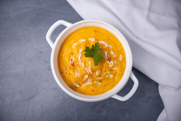 autumn pumpkin puree soup on a gray background