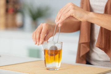 hands are making a cup of tea