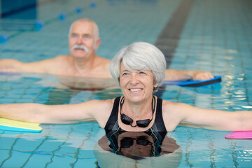 senior couple swimming in the pool
