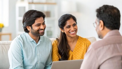 Happy Indian couple meeting consultant in living room — highlighting collaboration, advice, and success