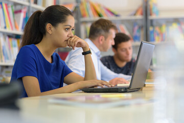 female student using laptop looking worried