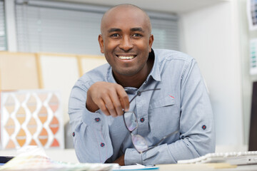 a smiling man in office