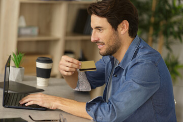 man using credit card for online shoping