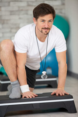 Fototapeta premium man is stepping on step machines
