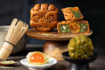 Vietnamese mooncake with matcha filling on wooden stand