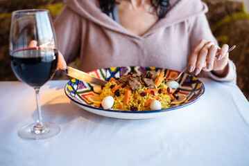 Woman enjoying a gourmet meal with red wine